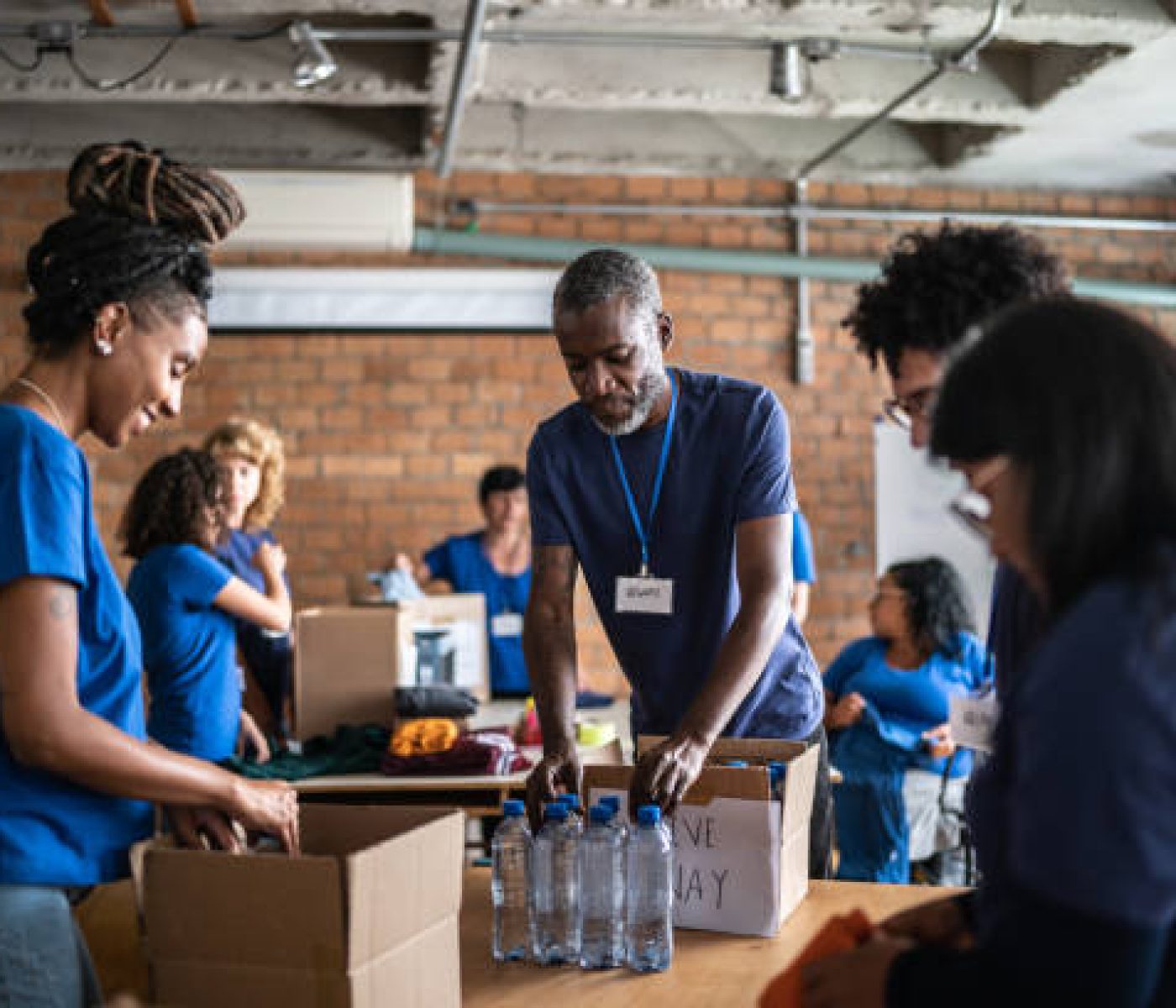 Volunteers arranging donations in a community charity donation center