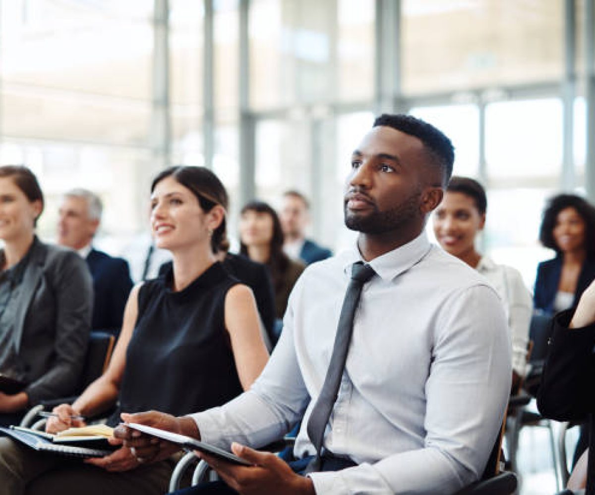 Shot of a group of businesspeople attending a conference